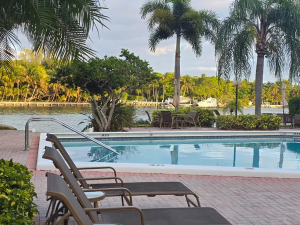 a view of a swimming pool with a table and chairs