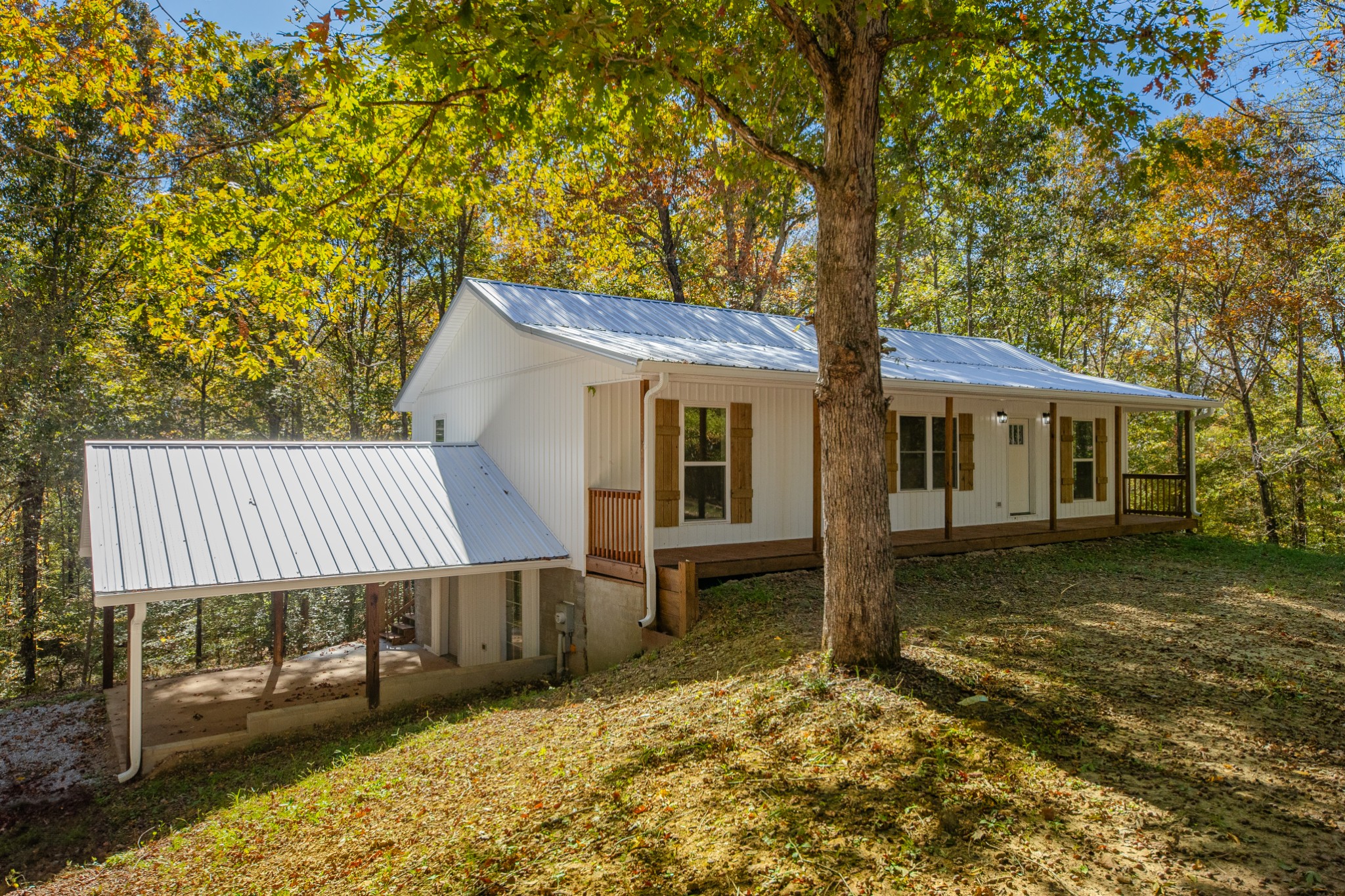 8240 Charlie Brown Road Centerville, TN 37033 - Photo 13 of 72 front view of a house with a chairs and table in the patio