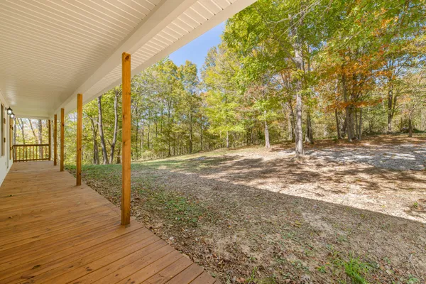 a view of a kitchen with wooden floor and windows