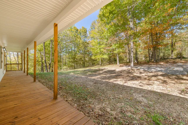 a view of a kitchen with wooden floor and windows