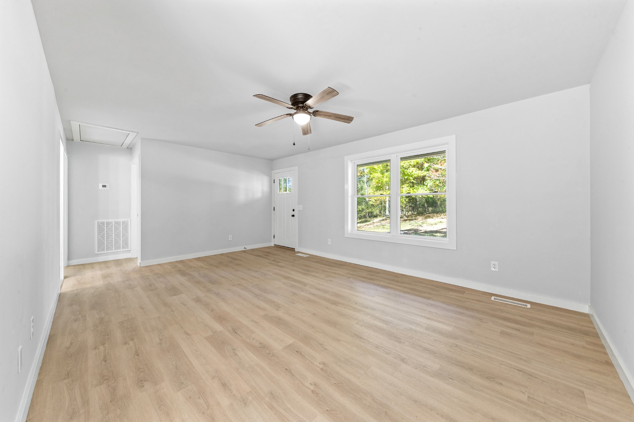 8240 Charlie Brown Road Centerville, TN 37033 - Photo 21 of 72 wooden floor in an empty room with a window