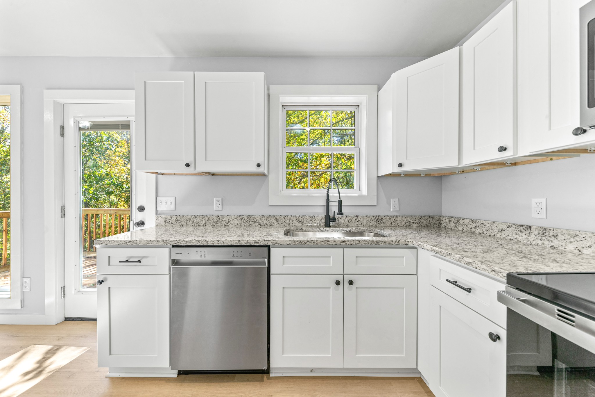 8240 Charlie Brown Road Centerville, TN 37033 - Photo 25 of 72 a kitchen with stainless steel appliances granite countertop a sink and cabinets with wooden floor