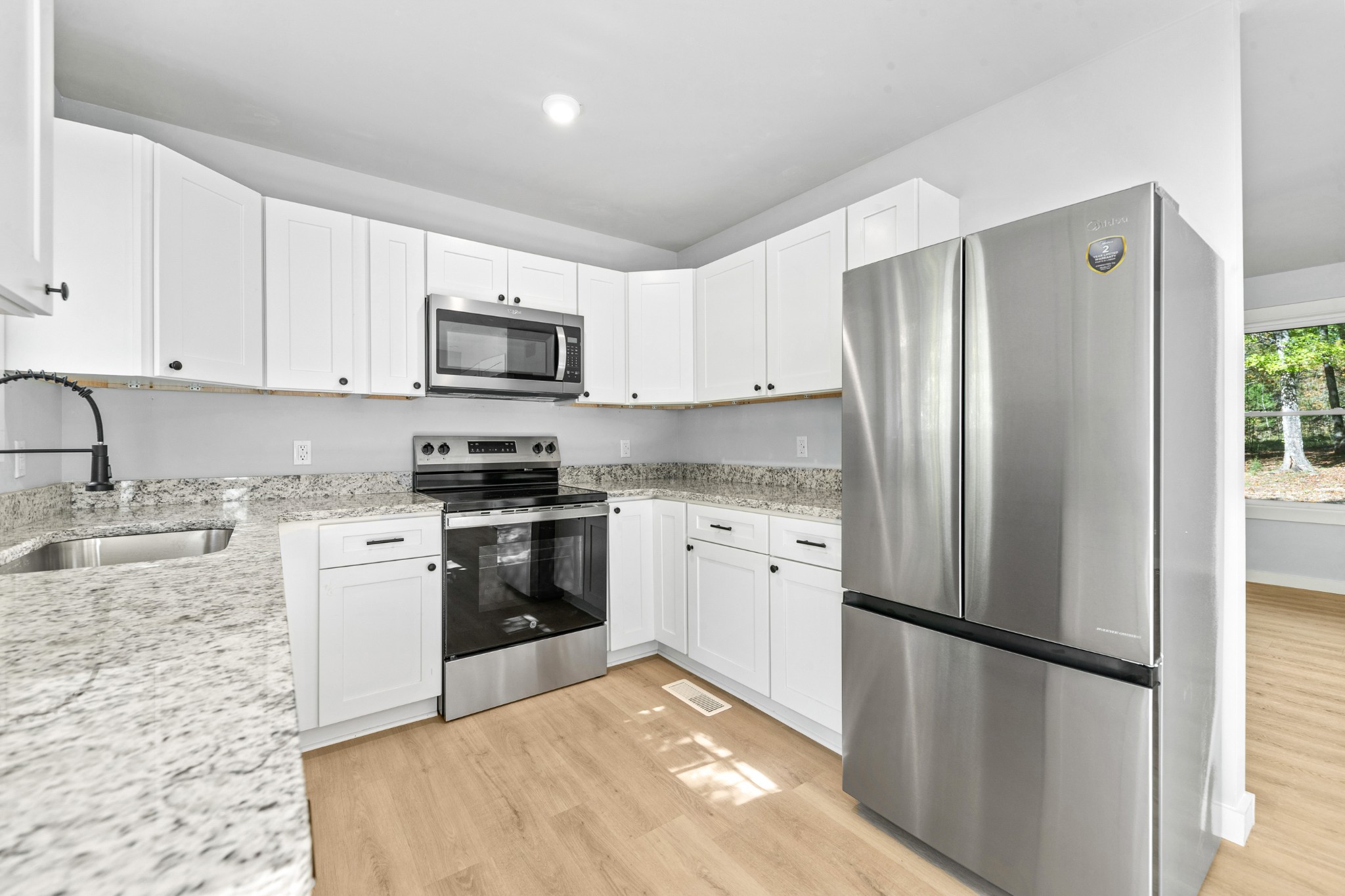 8240 Charlie Brown Road Centerville, TN 37033 - Photo 26 of 72 a kitchen with a refrigerator stove and sink