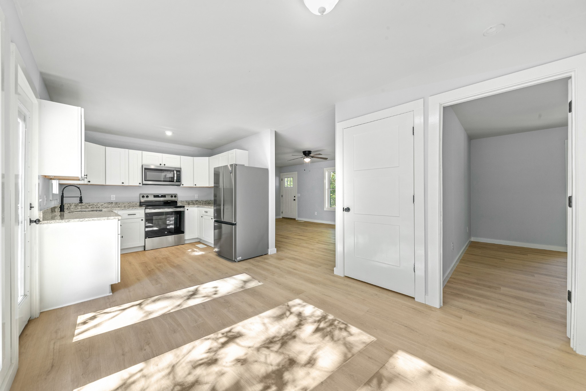 8240 Charlie Brown Road Centerville, TN 37033 - Photo 27 of 72 a view of a kitchen with refrigerator and wooden floor