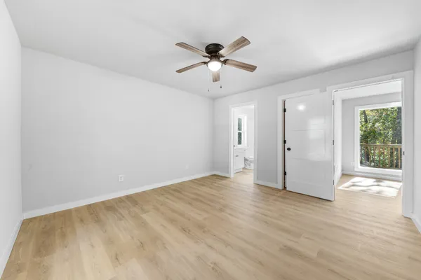a view of a livingroom with a window and a ceiling fan