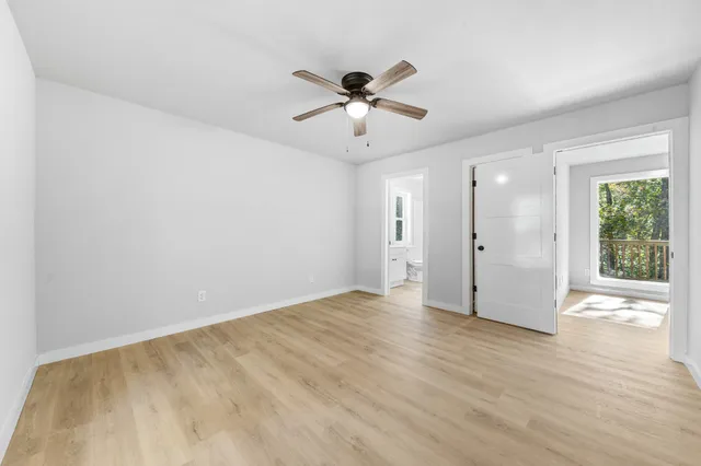 a view of a livingroom with a window and a ceiling fan