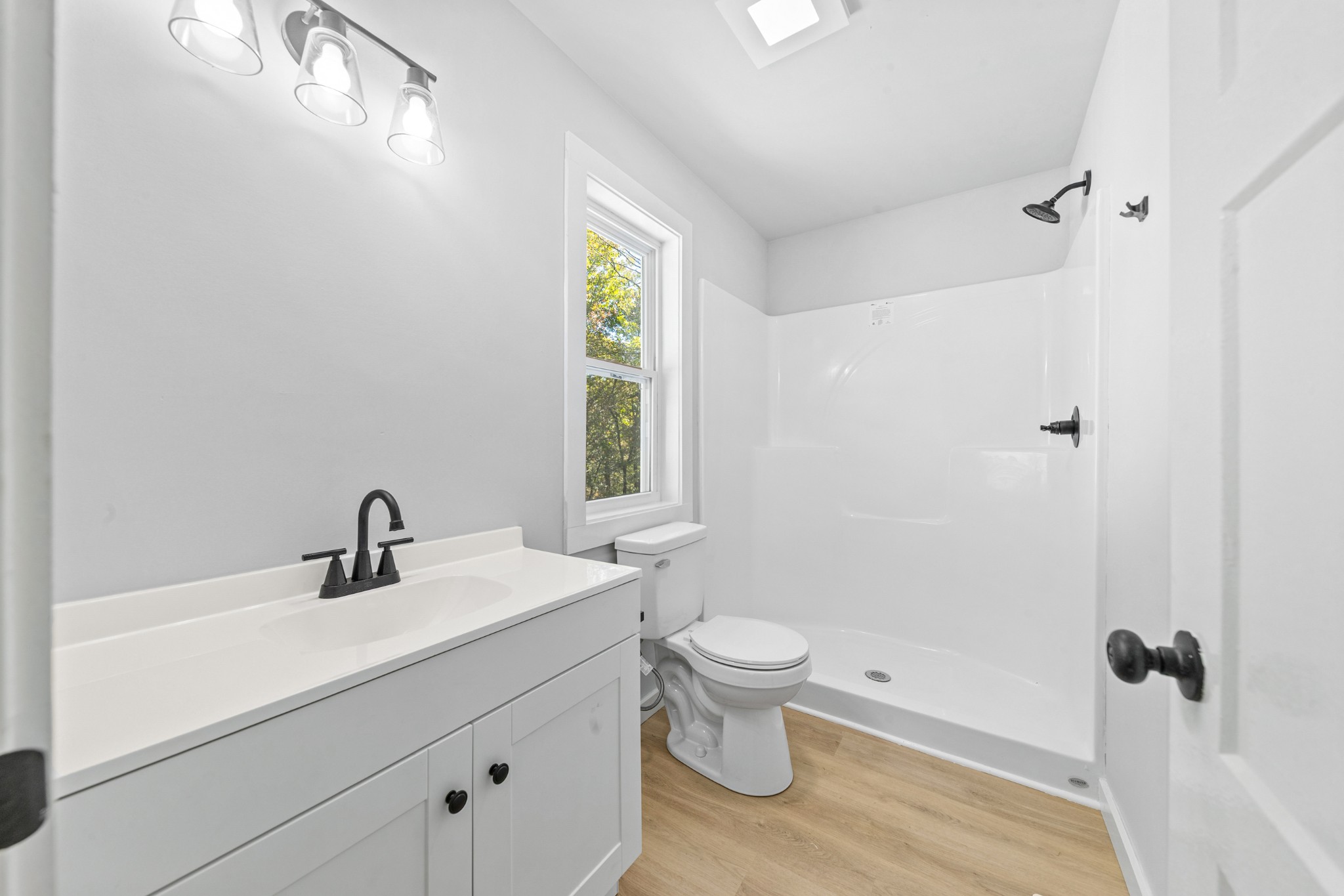 8240 Charlie Brown Road Centerville, TN 37033 - Photo 34 of 72 a bathroom with a sink a toilet and shower