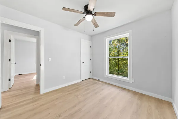 a backyard of a house with a large tree