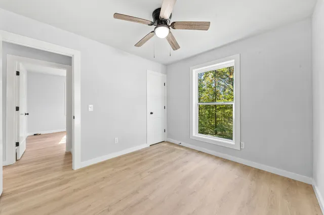 a backyard of a house with a large tree