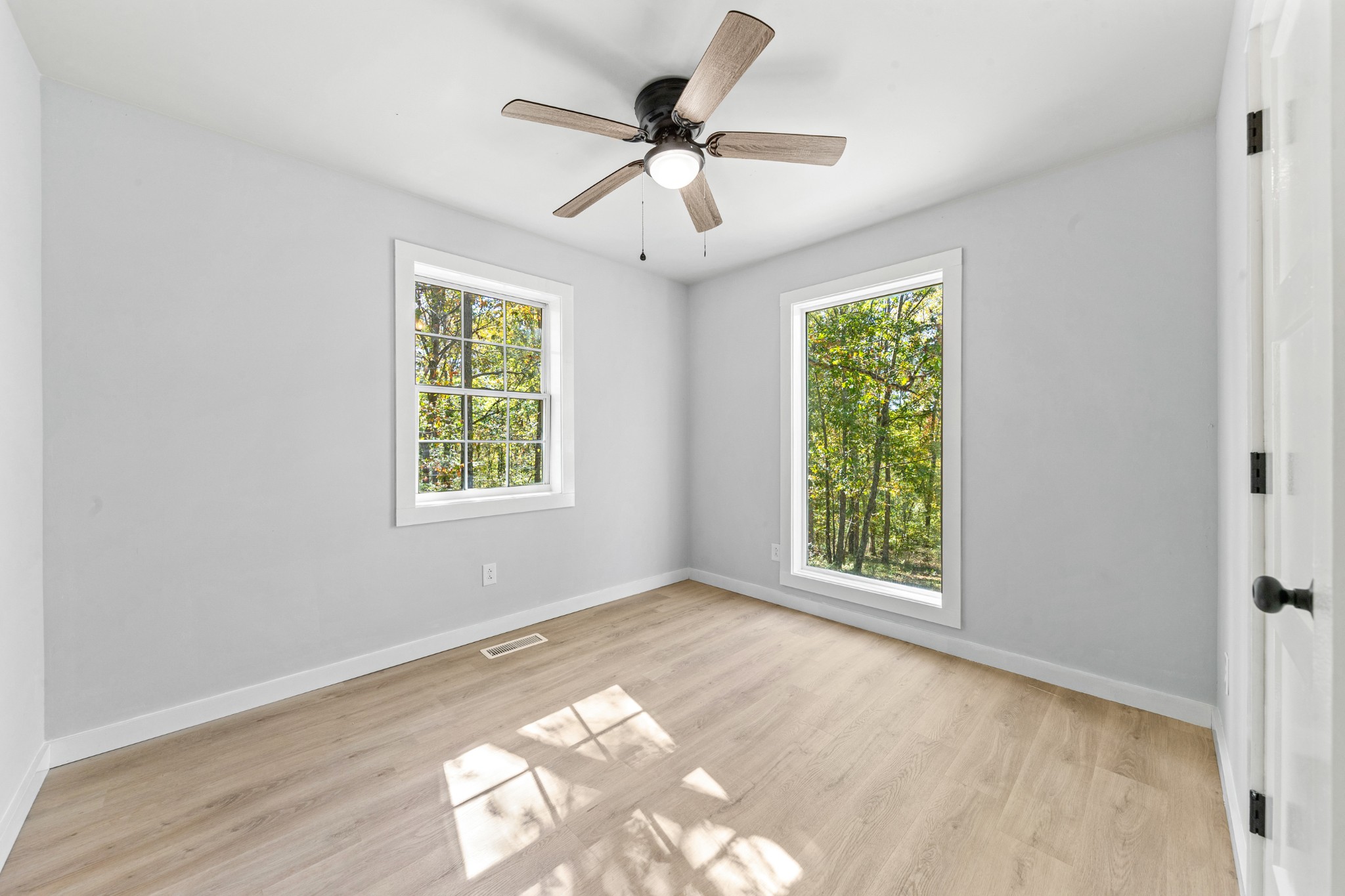 8240 Charlie Brown Road Centerville, TN 37033 - Photo 40 of 72 a view of an empty room with wooden floor and a window