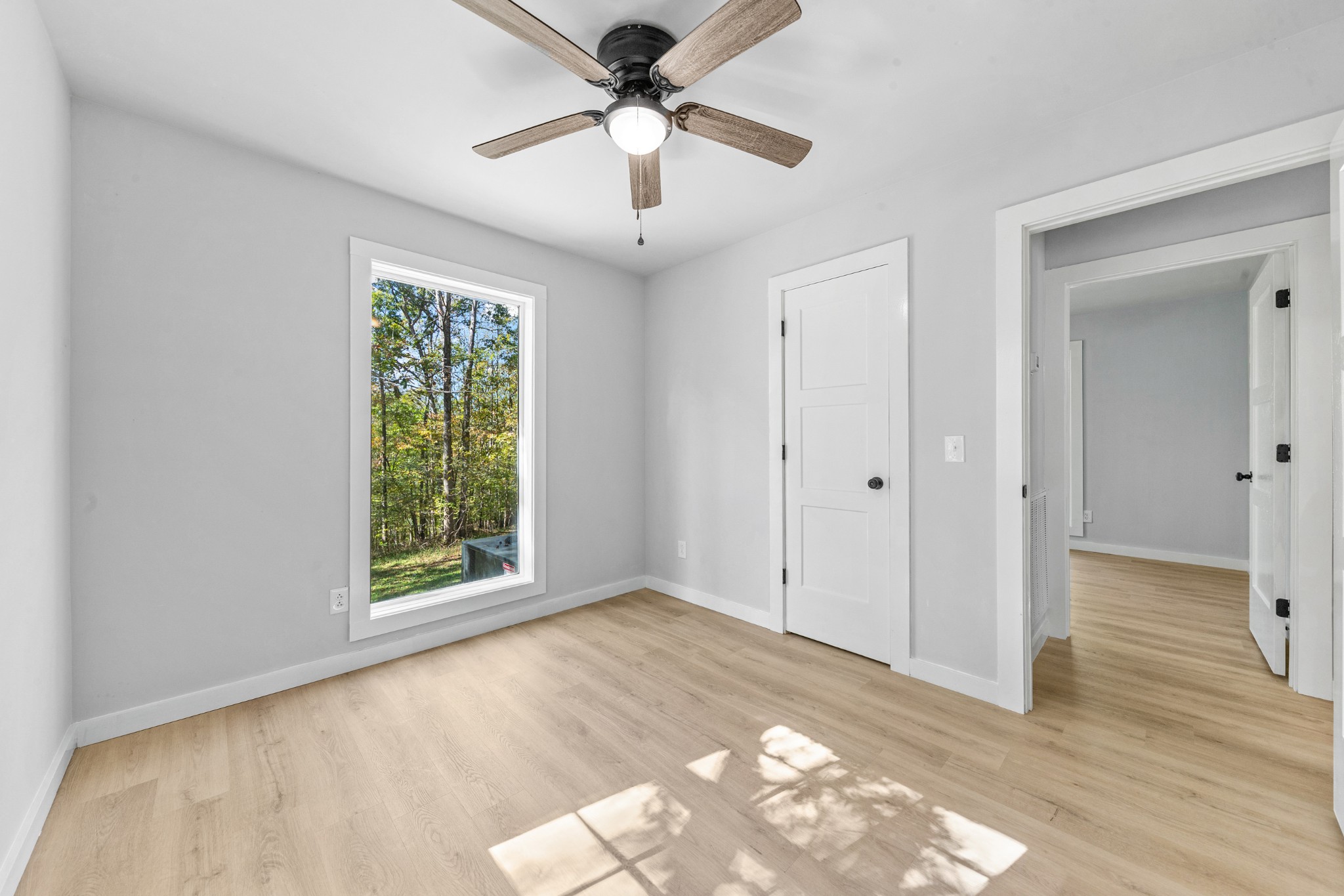 8240 Charlie Brown Road Centerville, TN 37033 - Photo 41 of 72 a view of a livingroom with a window and a ceiling fan