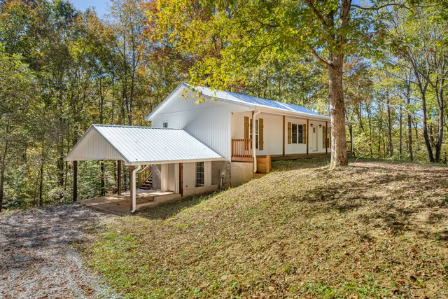 a house that has a tree in front of it