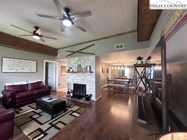 a living room with furniture fireplace and flat screen tv
