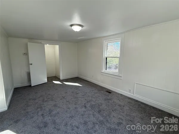 an empty room with a empty space and windows