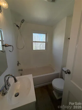 a bathroom with a sink mirror toilet and shower