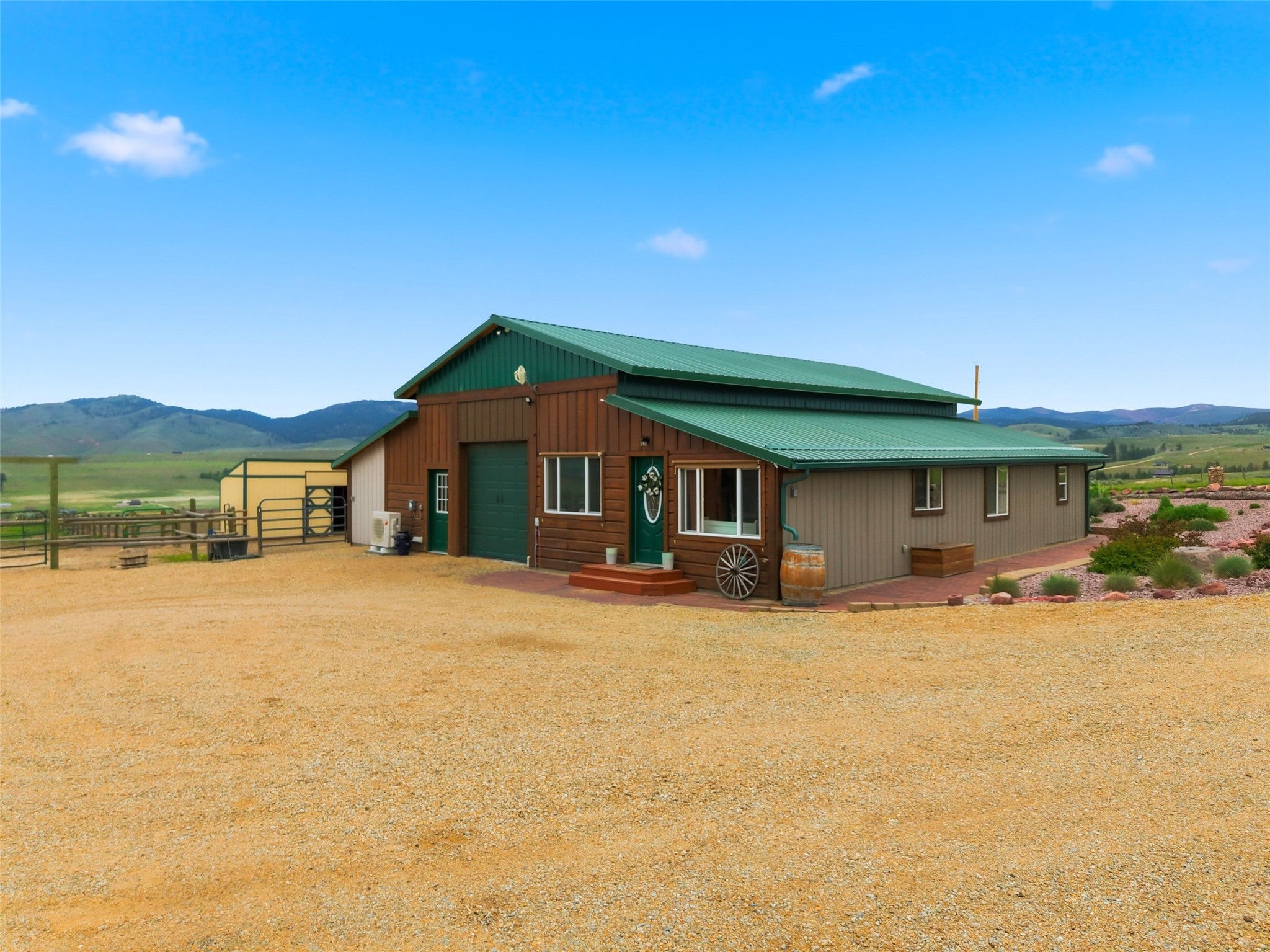 679 Hidden Valley Road North Florence, MT 59833 - Photo 58 of 85 Rustic-style building featuring a green metal roof and a combination of wood siding and log accents