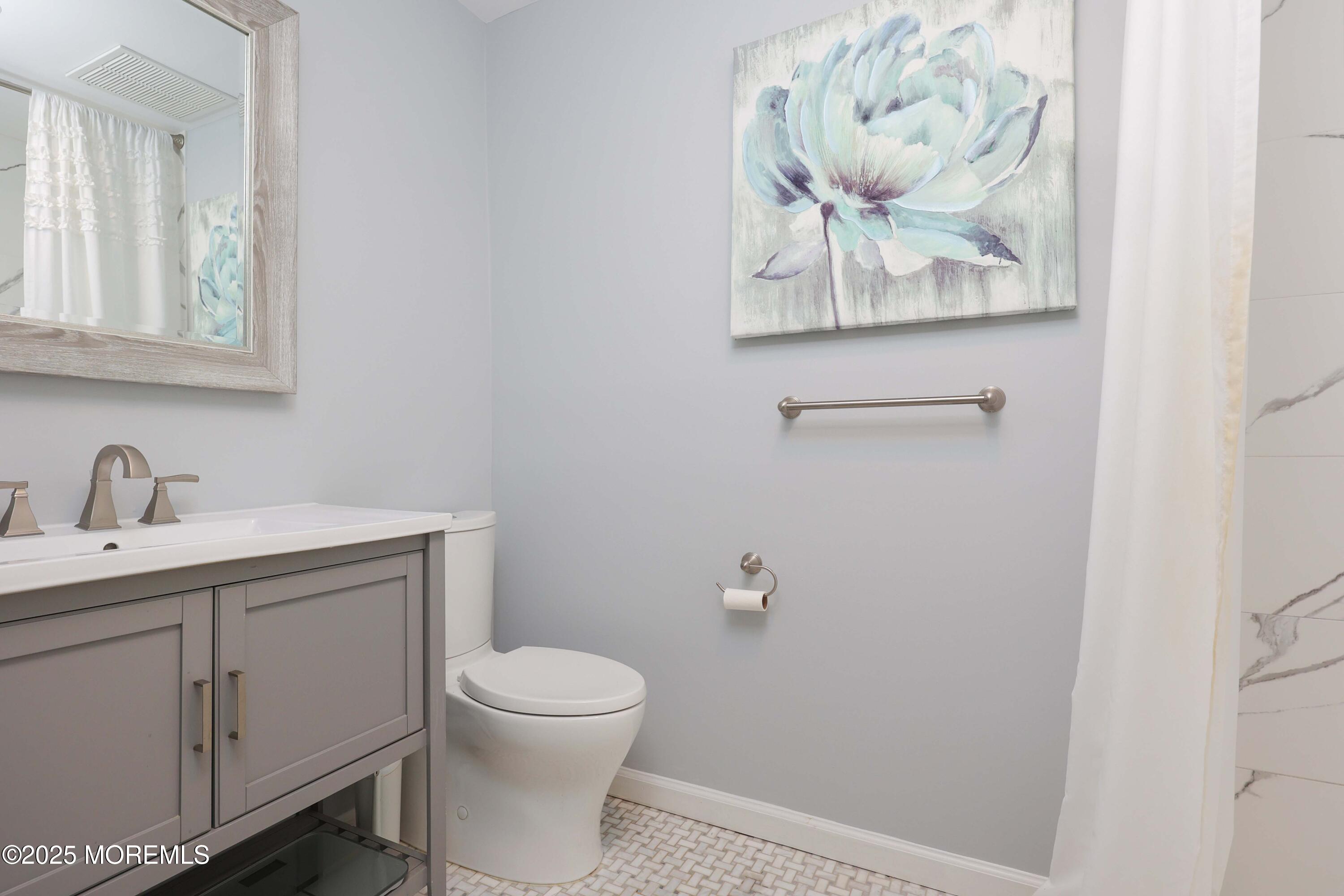 16 Concord Court Red Bank, NJ 07701 - Photo 23 of 63 a bathroom with a toilet sink and mirror