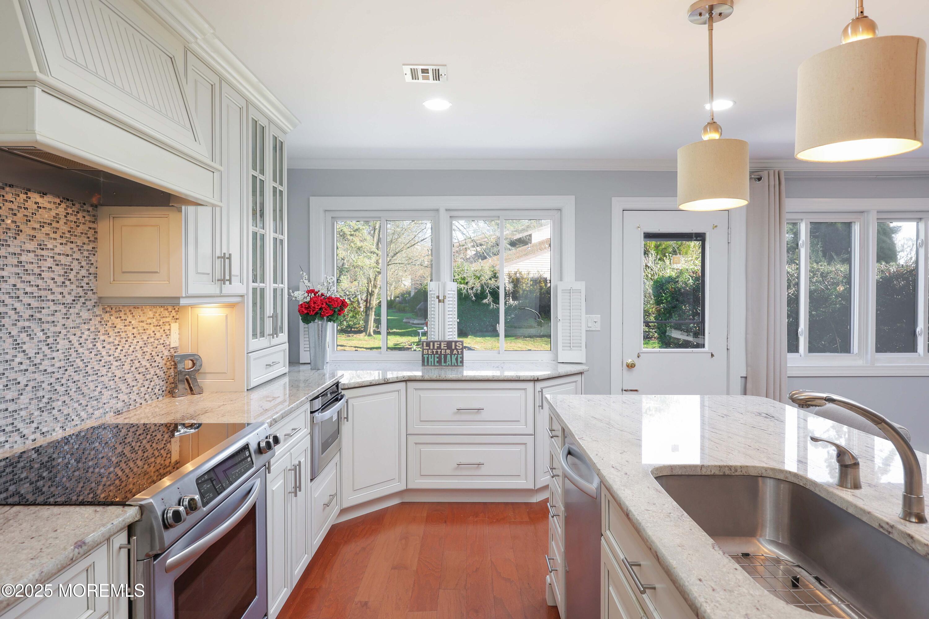 16 Concord Court Red Bank, NJ 07701 - Photo 6 of 63 a kitchen with a sink stove and cabinets