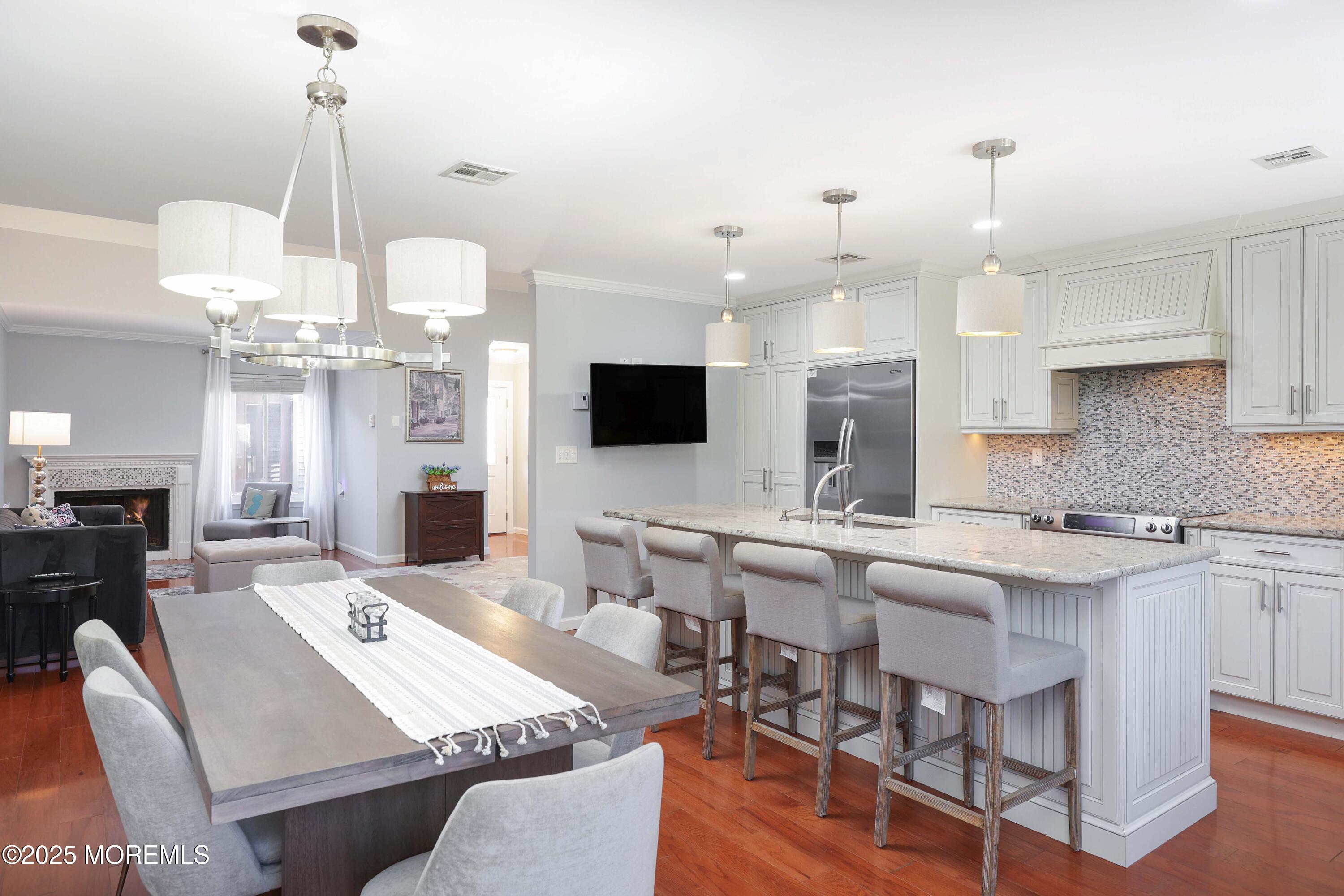16 Concord Court Red Bank, NJ 07701 - Photo 10 of 63 a large kitchen with kitchen island stainless steel appliances a dining table and chairs