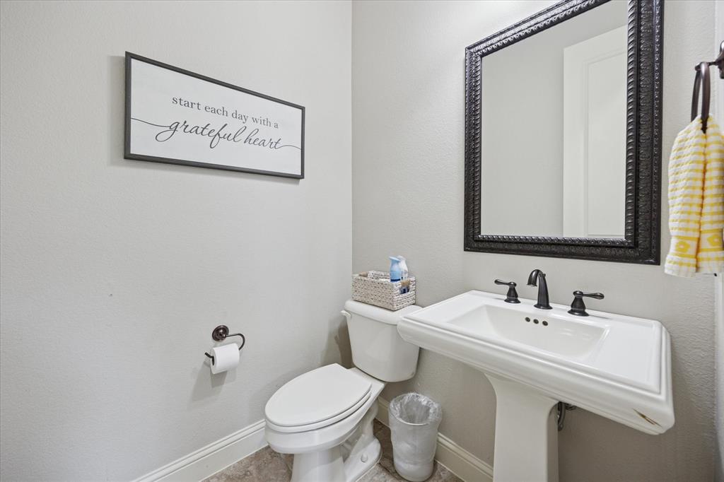 580 Butchart Drive Prosper, TX 75078 - Photo 21 of 40 Half bath featuring baseboards, toilet, and a sink