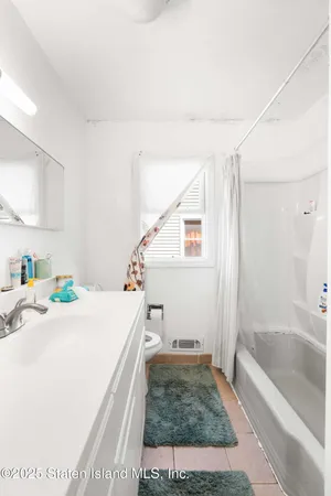 a bathroom with a bathtub and a sink