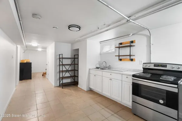 a kitchen with stainless steel appliances granite countertop a stove and a sink