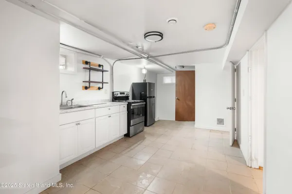 a kitchen with a sink cabinets and stainless steel appliances