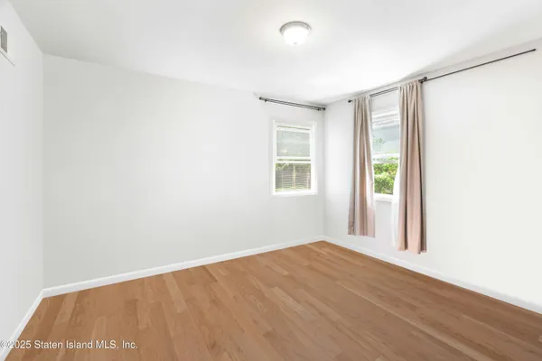 an empty room with windows and closet