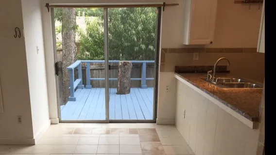 a kitchen with a sink and wooden cabinets