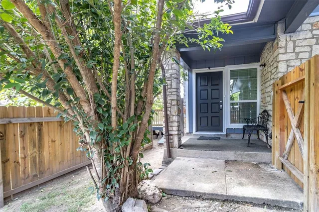a view of a house with a tree in front