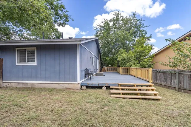 a view of a wooden deck and a backyard