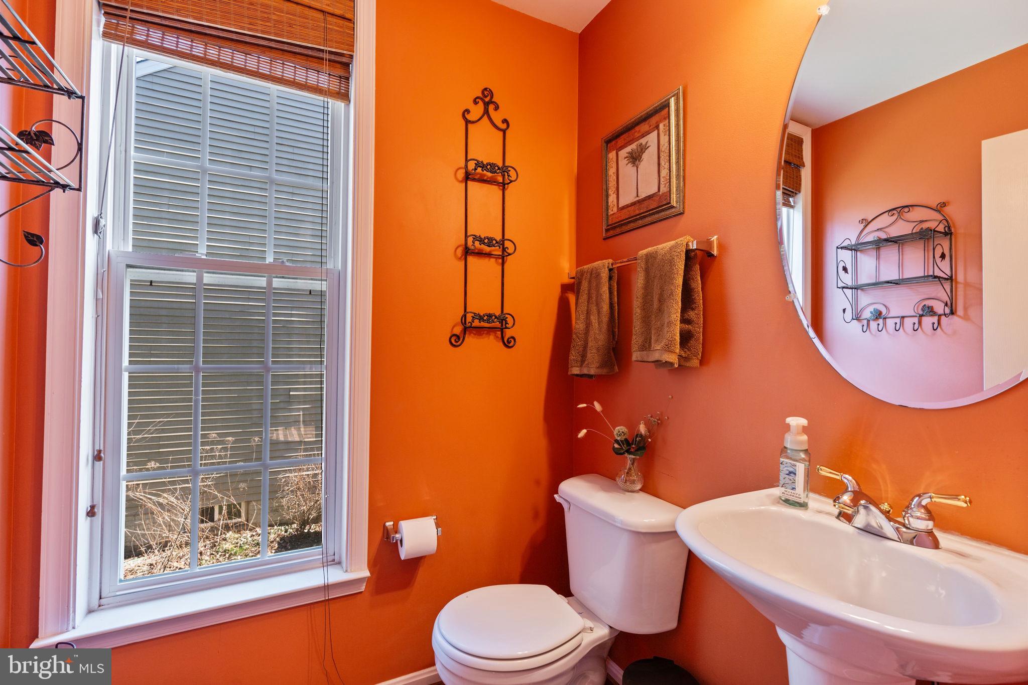 12298 Wake Forest Road Clarksville, MD 21029 - Photo 15 of 46 a bathroom with a sink a mirror a toilet and a shower