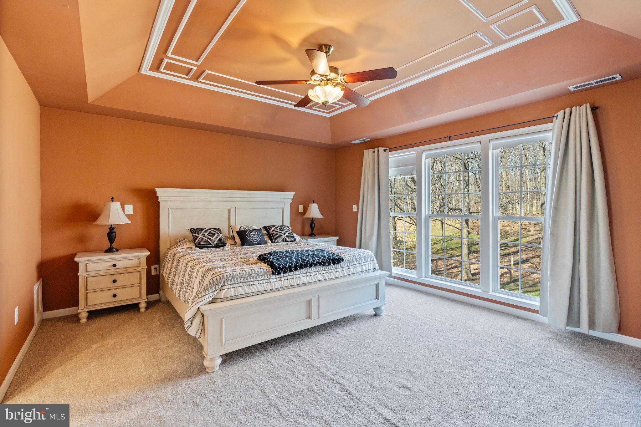 12298 Wake Forest Road Clarksville, MD 21029 - Photo 18 of 46 a bed room with a bed and a chandelier