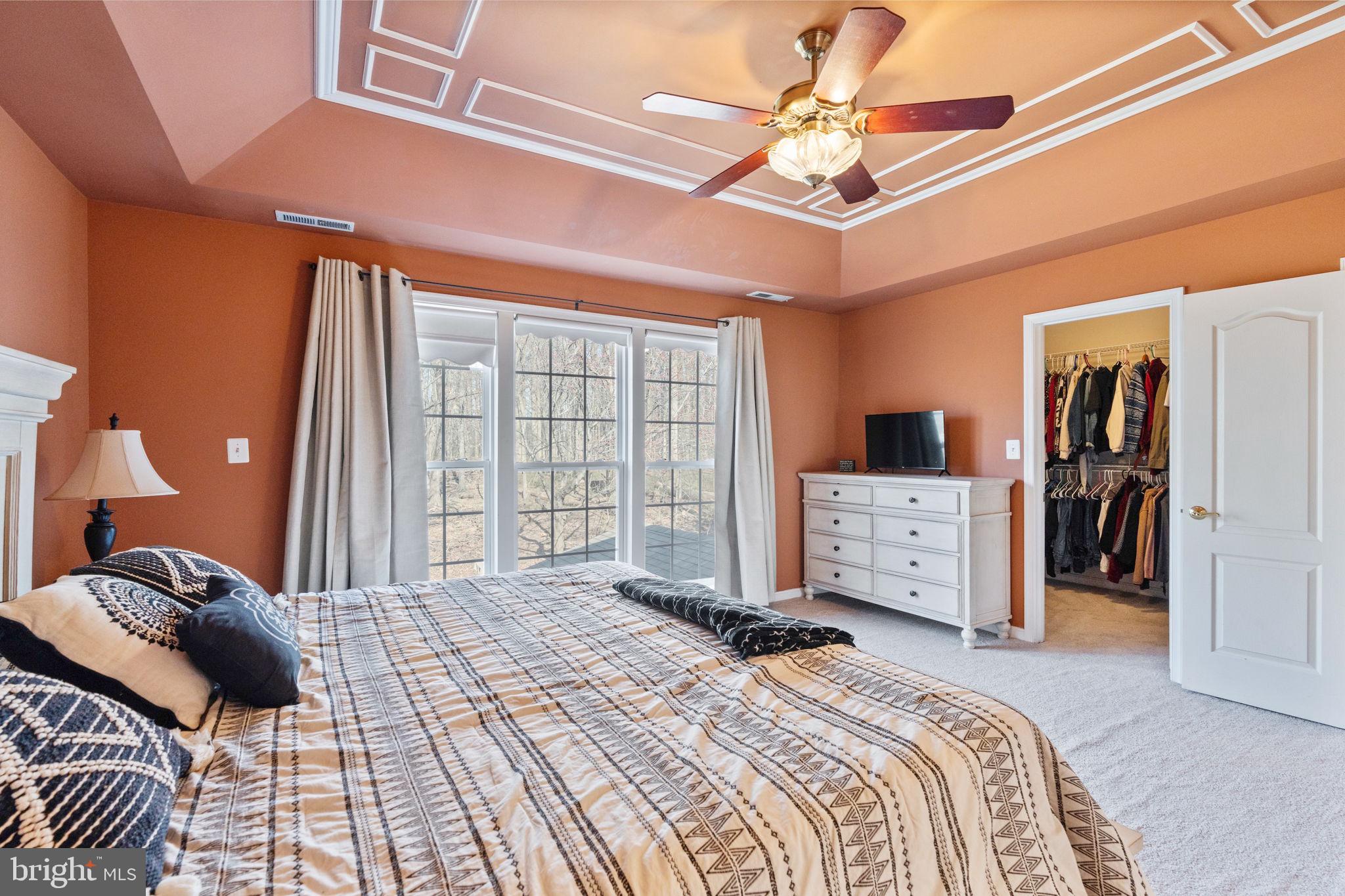 12298 Wake Forest Road Clarksville, MD 21029 - Photo 19 of 46 a bedroom with a bed a large mirror and furniture