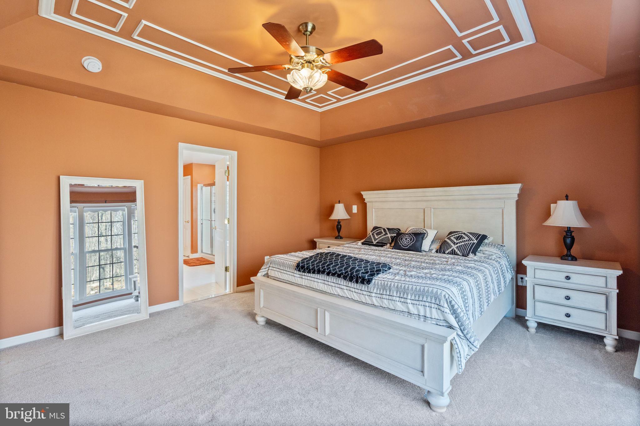 12298 Wake Forest Road Clarksville, MD 21029 - Photo 20 of 46 a bedroom with a bed and a ceiling fan