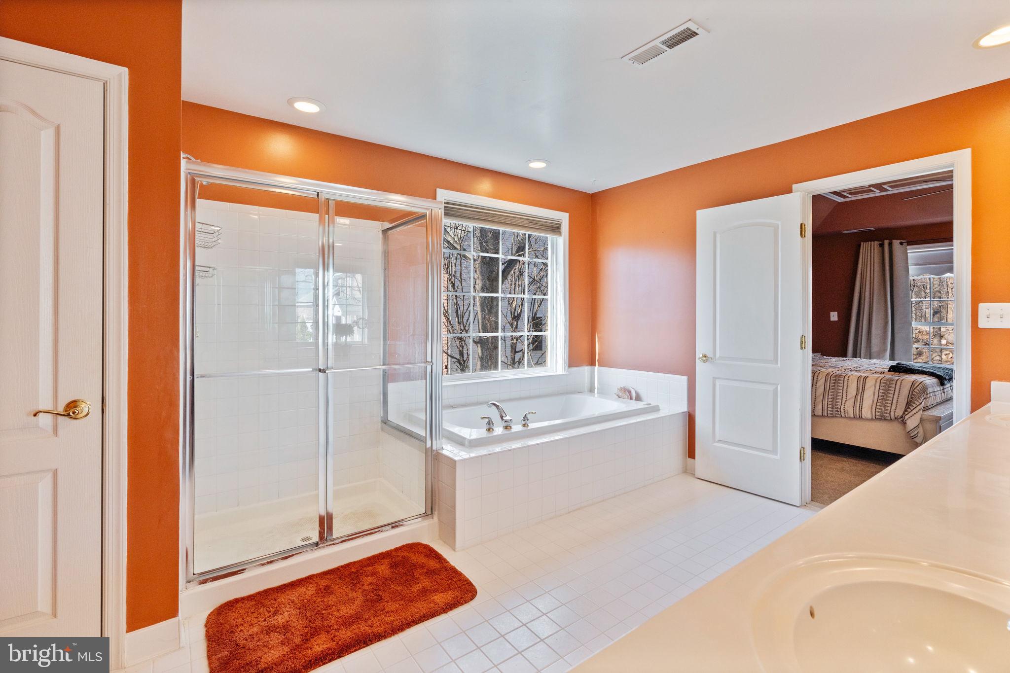 12298 Wake Forest Road Clarksville, MD 21029 - Photo 22 of 46 a spacious bathroom with a tub sink and mirror