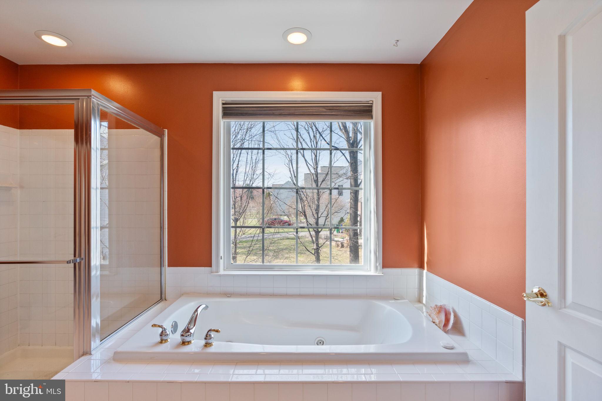 12298 Wake Forest Road Clarksville, MD 21029 - Photo 23 of 46 a bathroom with a bathtub and a window