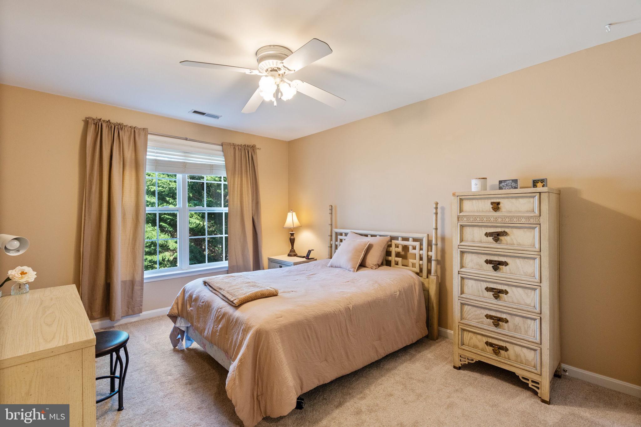 12298 Wake Forest Road Clarksville, MD 21029 - Photo 26 of 46 a bedroom with a bed and a chandelier