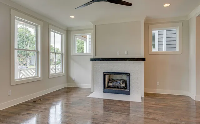 a view of a livingroom with a fireplace and window