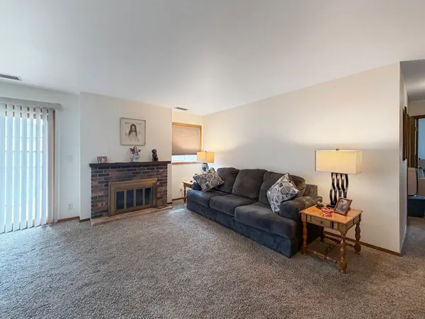 a living room with furniture and a lamp