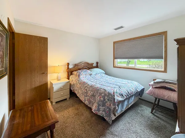 a bedroom with a bed and window