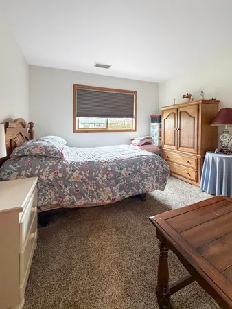 a bedroom with bed and a window