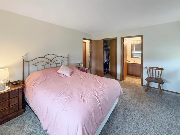 a bedroom with a bed and a couch