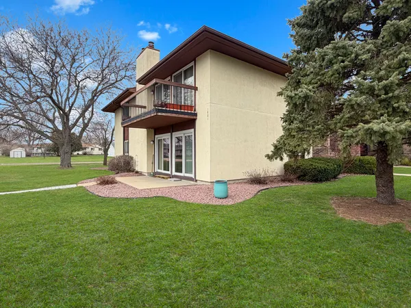 a front view of a house with yard and green space