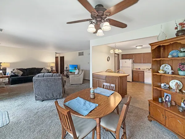 a dining room with furniture and wooden floor