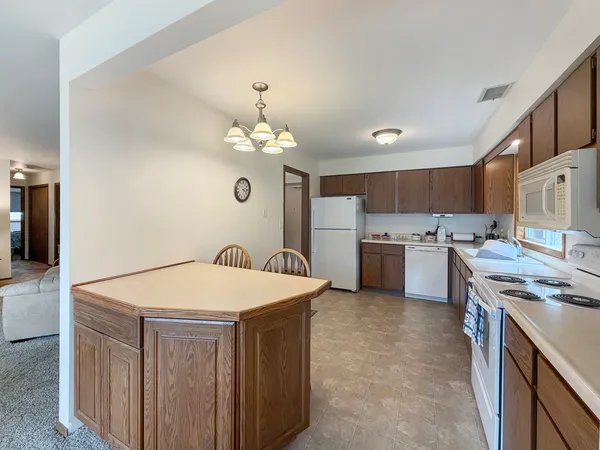 a kitchen that has a lot of cabinets in it