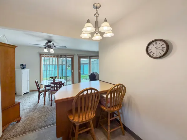 a view of a dining room with furniture and chandelier