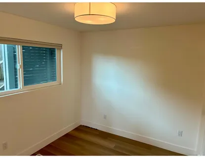 an empty room with wooden floor and closet