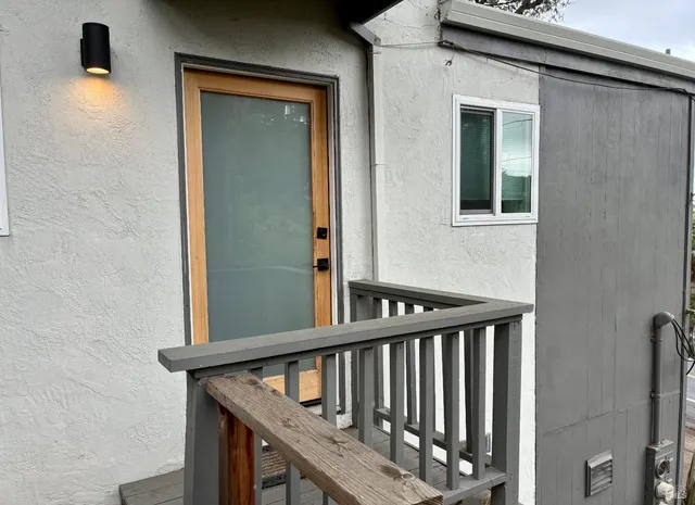 a view of staircase with railing and a window