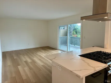 a large kitchen with wooden floor and a sink